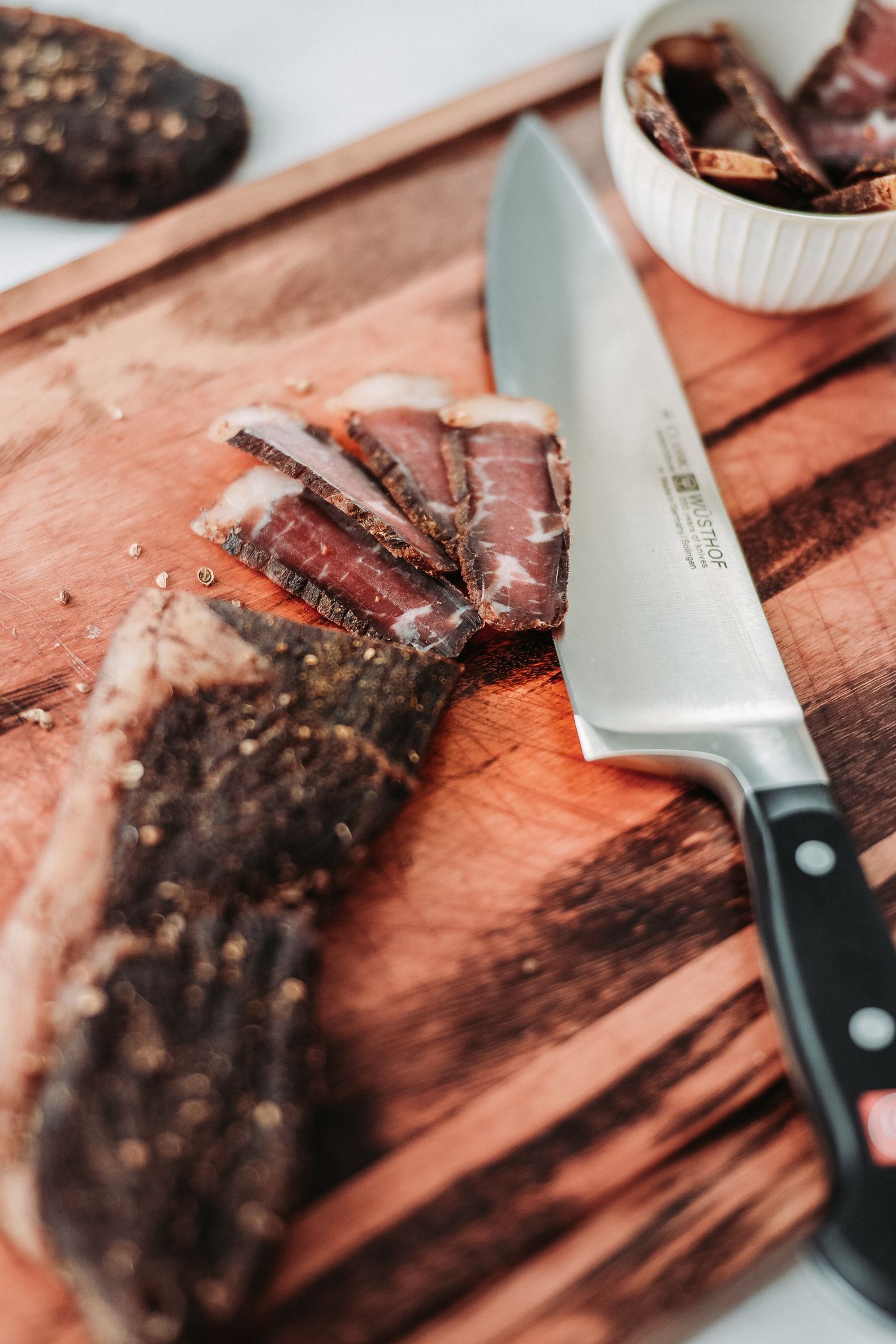 Sliced biltong and a knife on the counter block